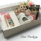 Care package with mug, fudge, and stationery items in a box