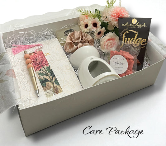 Care package with mug, fudge, and stationery items in a box